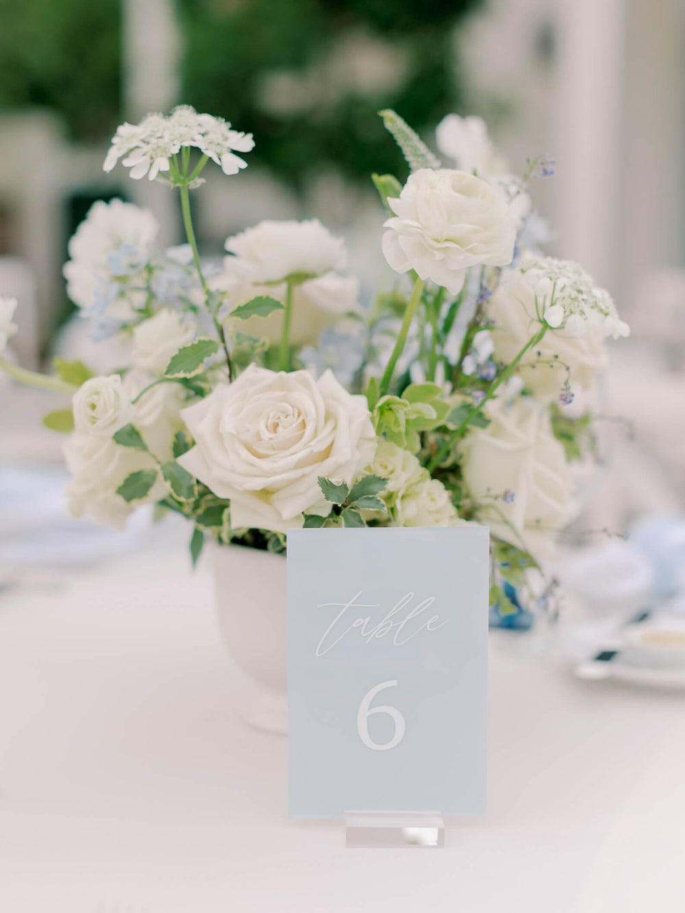 Acrylic table number with white florals at Grayce and Reid’s wedding