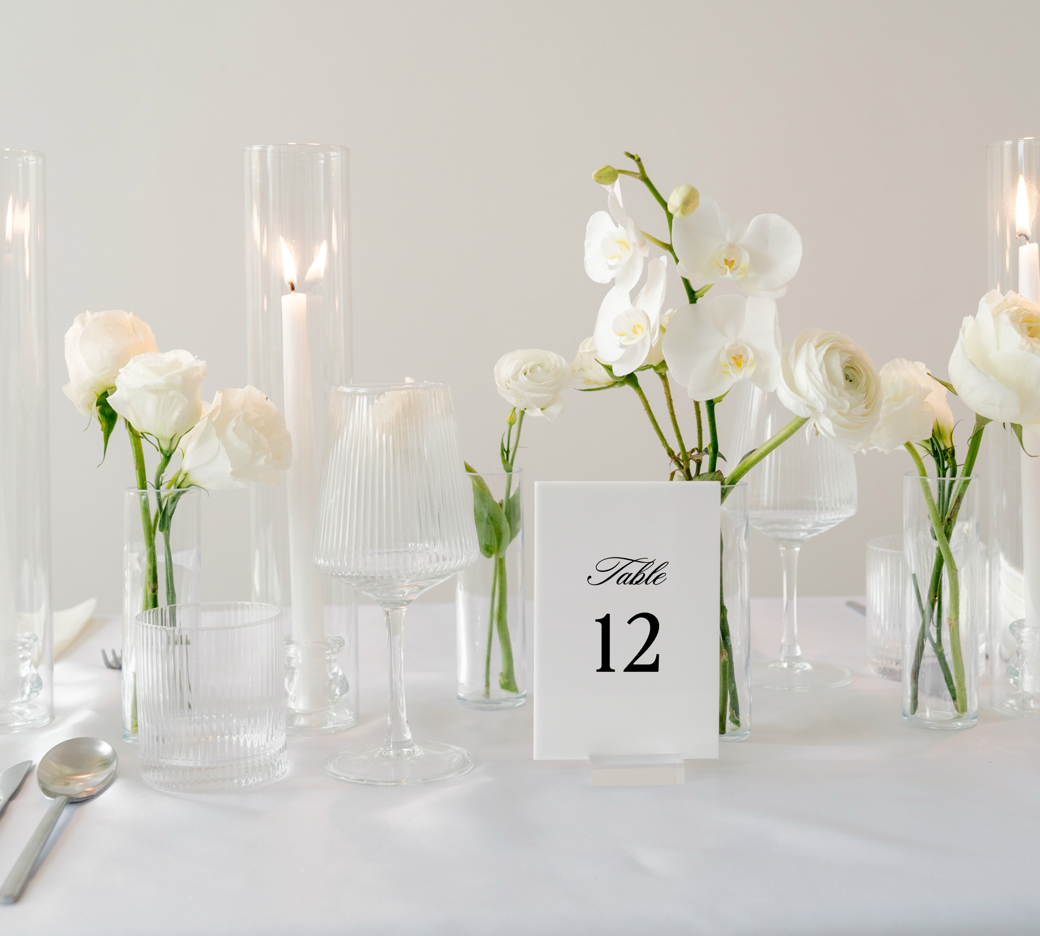Acrylic wedding table numbers on clear stands in Haven lettering