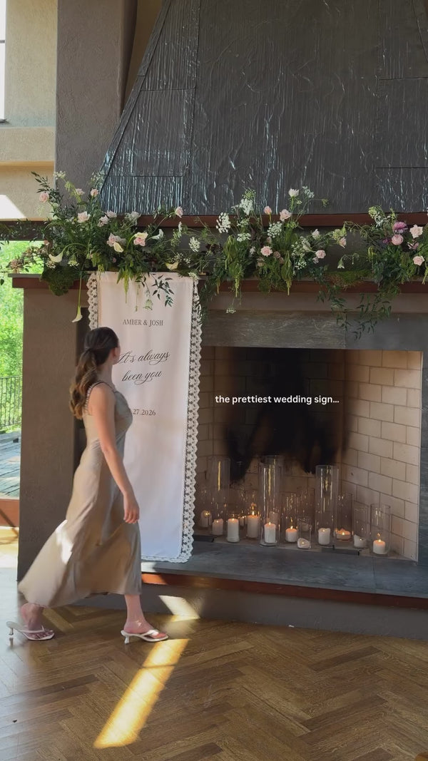 Linen and lace wedding welcome sign on a mantel